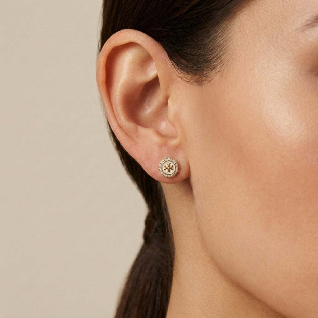 Model wearing Tory Burch Moondance Crystal Studs, showing the asymmetrical celestial look