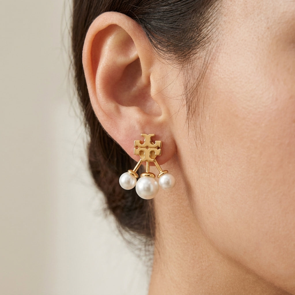 Model wearing Tory Burch Moondance Pearl Front-Back Earrings, demonstrating the trendy ear jacket look