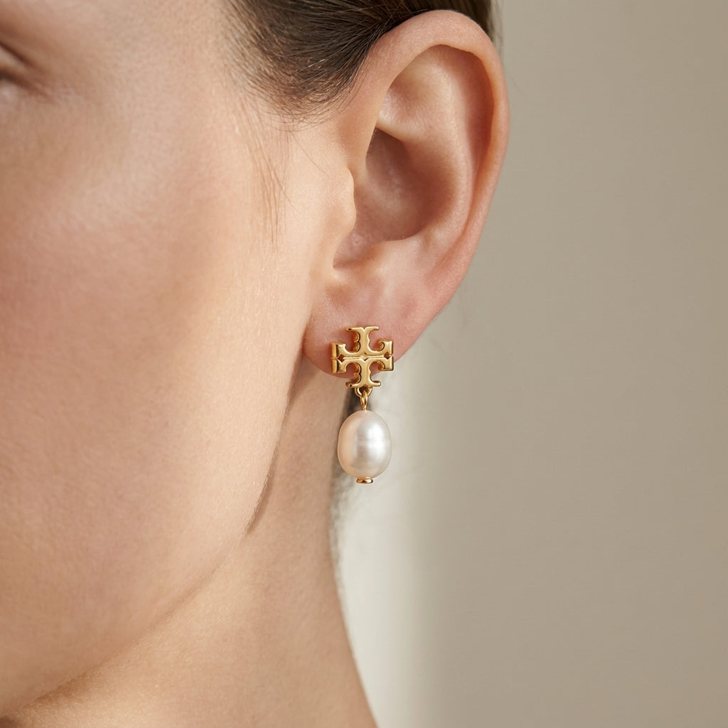 Model wearing Tory Burch Moondance Pearl Drop Earrings, showcasing an elegant and celestial aesthetic