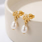 Macro detail of the lustrous pearl and the intricate crystal setting on Moondance celestial earrings