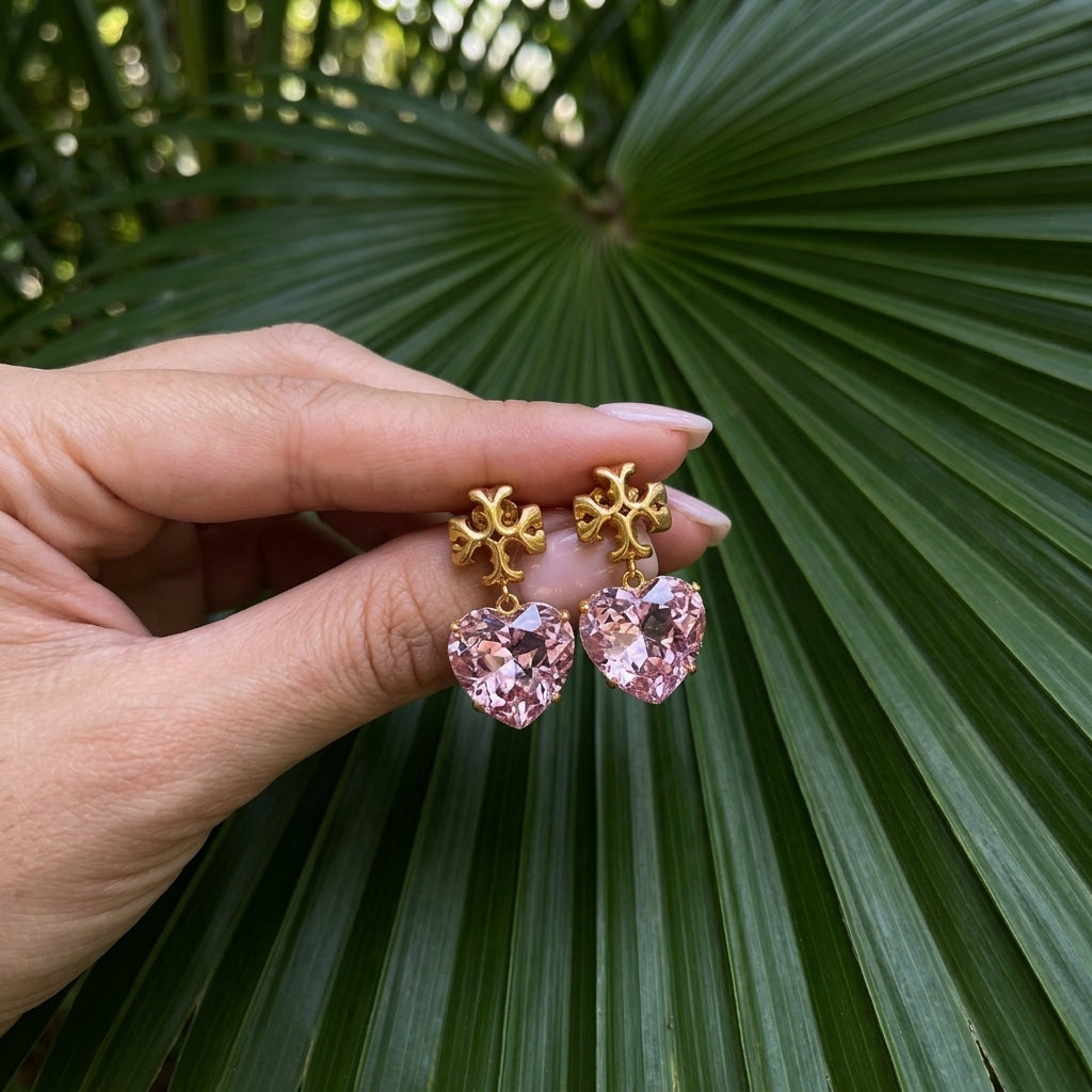 Hand-held scale reference of Tory Burch Heart Drop Earrings to show the dangle length and heart size