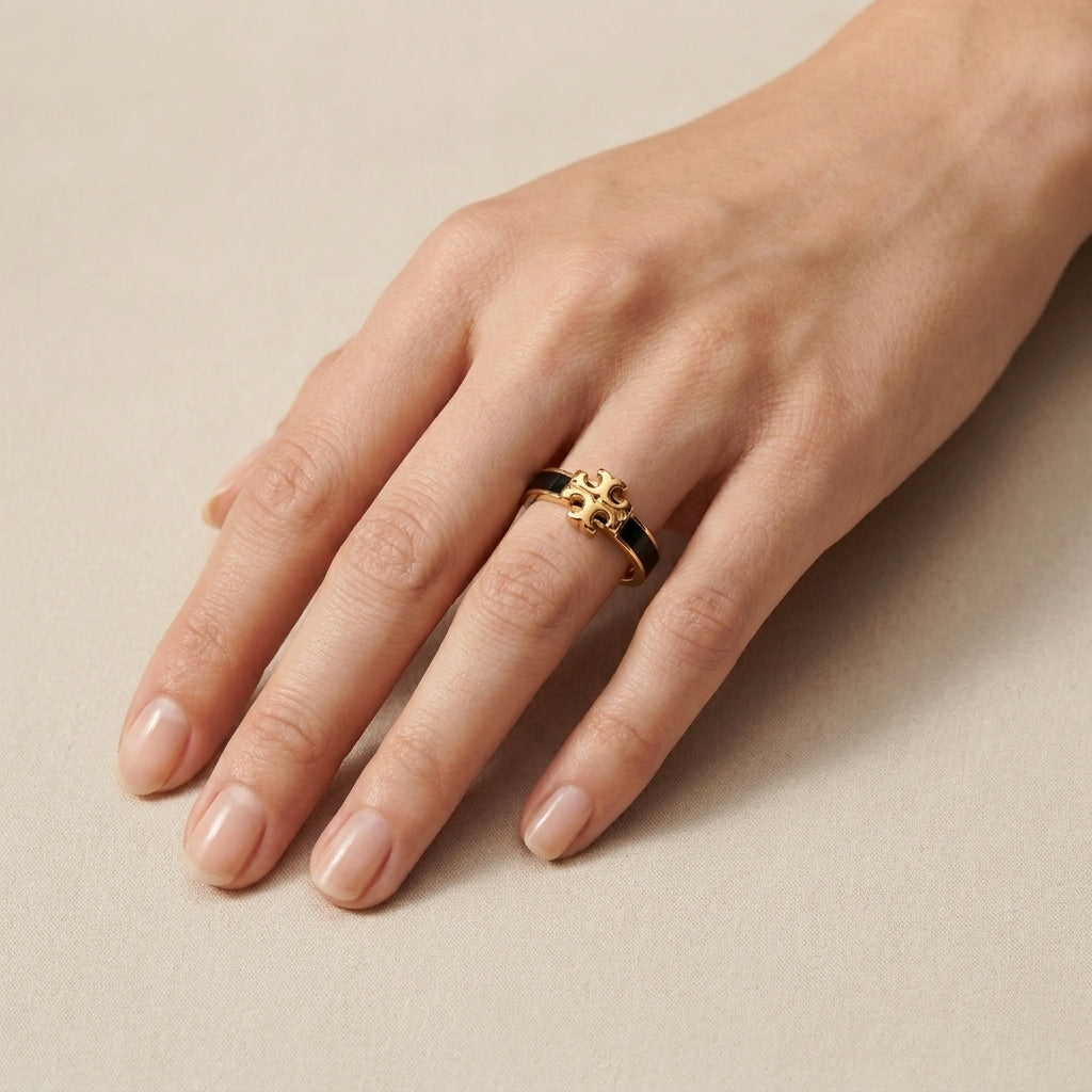 Hand-worn view of Tory Burch Black Enamel Ring to show the bold statement width and fit