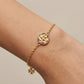 Model wearing Tory Burch Kira Flower Bracelet, an elegant feminine accessory for daily wear