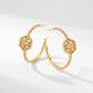 Macro detail of the embossed Double T logo and the vintage-inspired milgrain beading on hex hoops