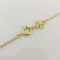 Detail of the lobster clasp and adjustable extender chain on the Tory Burch interlocking necklace with a mini logo charm.