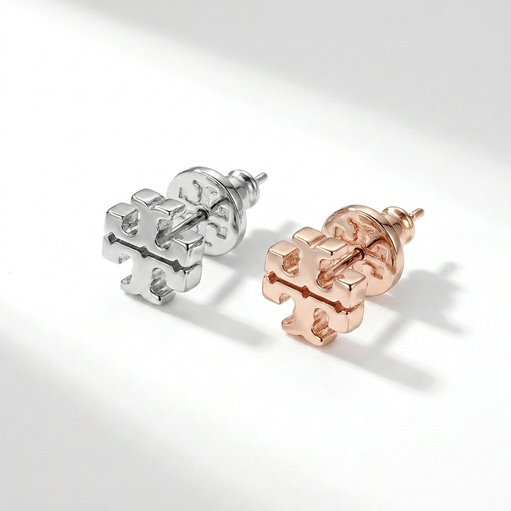 Angled view of Tory Burch Icon Stud Earrings showing 3D structure and thickness of the logo