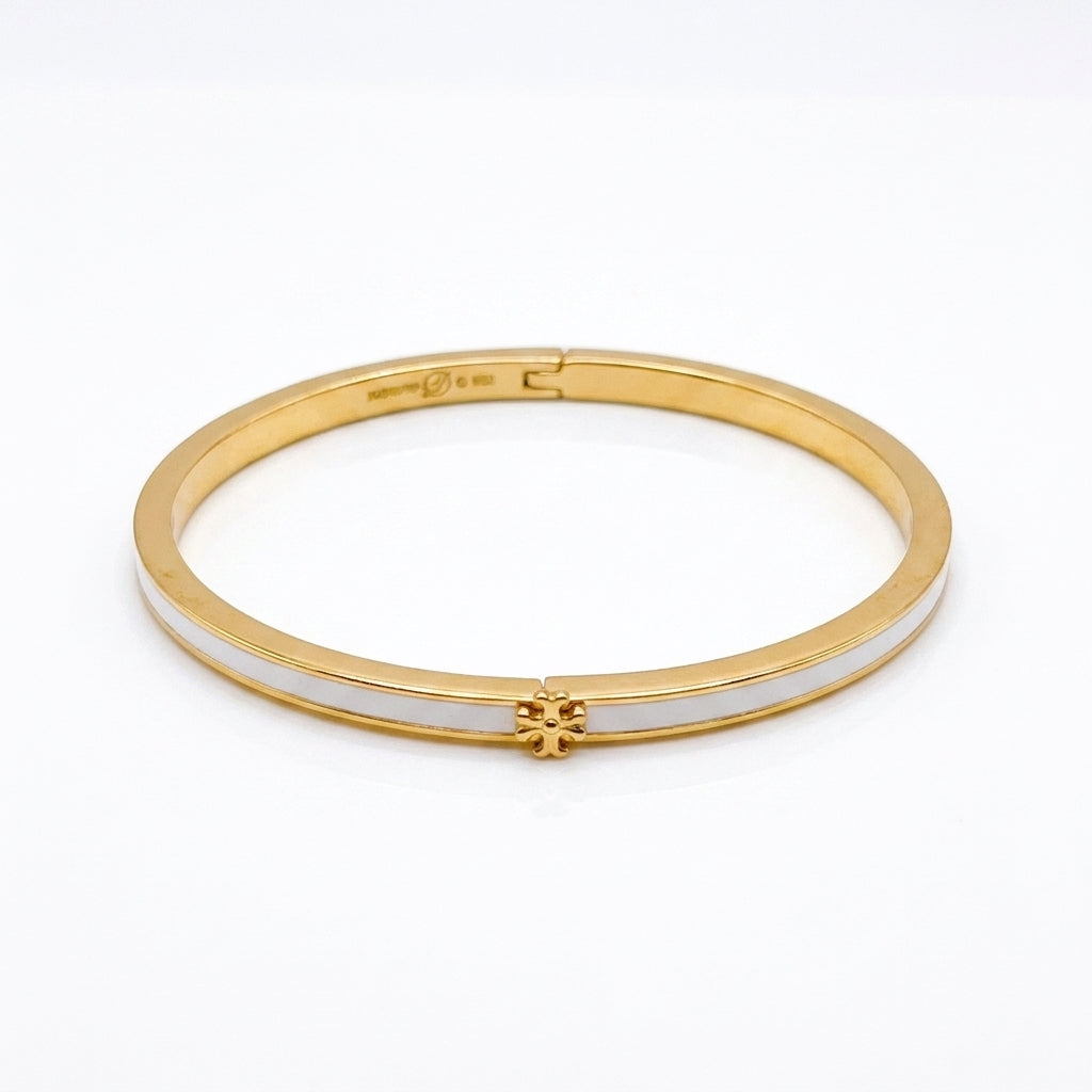 Tory Burch Icon Thin Enamel Bracelet in gold-tone with white enamel inlay and iconic Double T logo