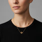Model wearing Tory Burch Kira Chevron Necklace, an elegant choice for minimalist layering