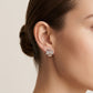 Close-up of a model wearing Kira Chevron Studs, showcasing a modern and elegant ear stack look