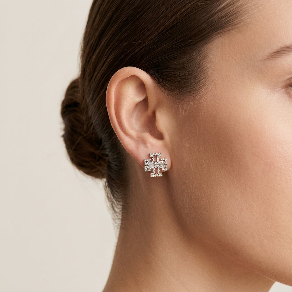 Close-up of a model wearing Kira Chevron Studs, showcasing a modern and elegant ear stack look