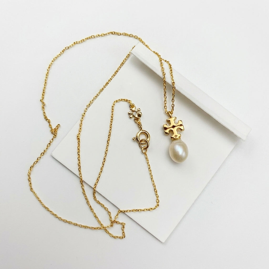 Tory Burch Kira Pearl Pendant Necklace in gold-tone featuring a Chevron-patterned Double T logo