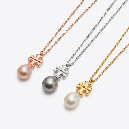 Three pearl necklaces with different colored chains on a white background