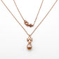 Tory Burch Kira Pearl Pendant Necklace in rose-tone featuring a Chevron-patterned Double T logobackground