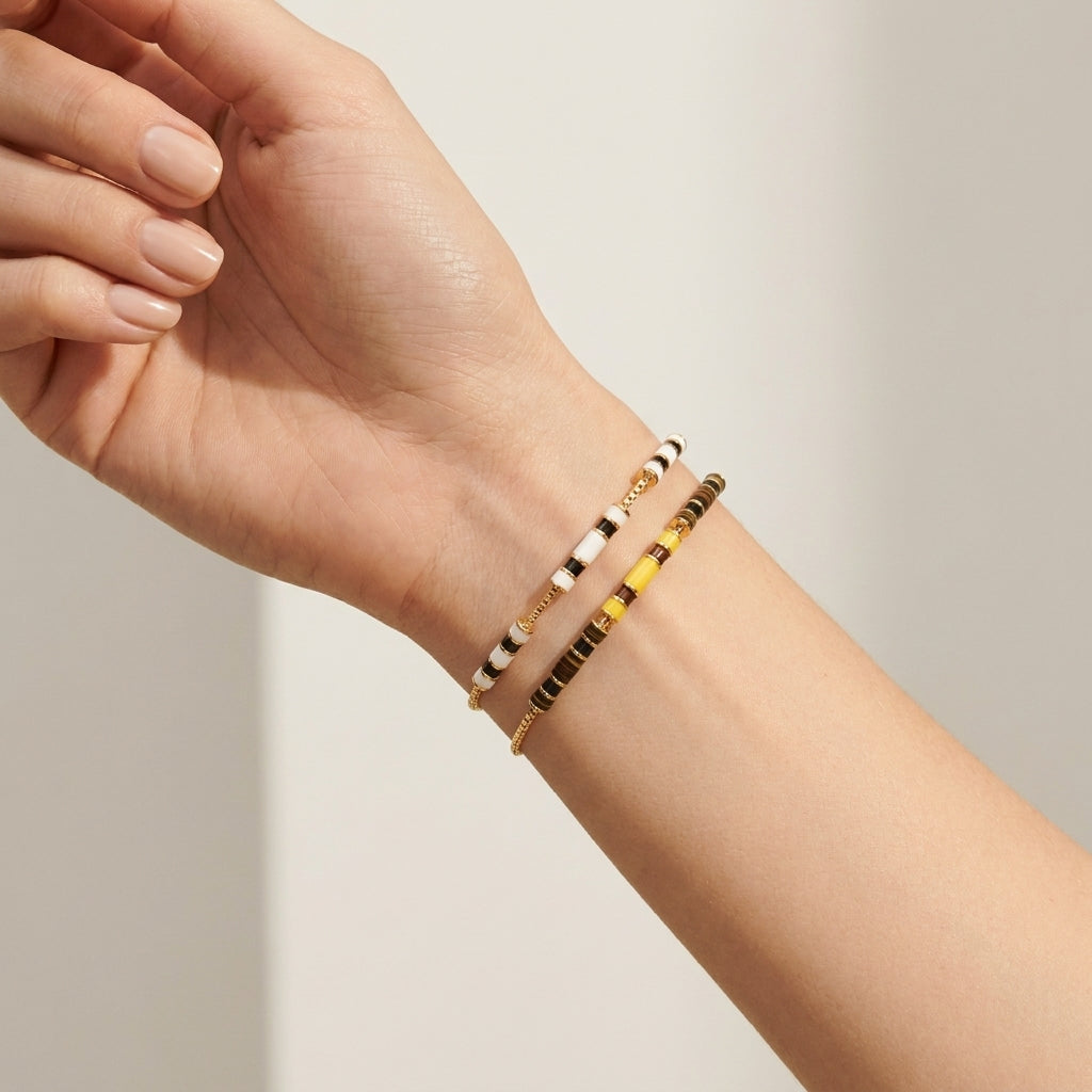Model wearing Tory Burch Kira Enamel Bar Bracelet, perfect for a minimalist jewelry look