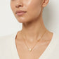 Model wearing Tory Burch Kira Heart Necklace, an elegant choice for a minimalist jewelry look