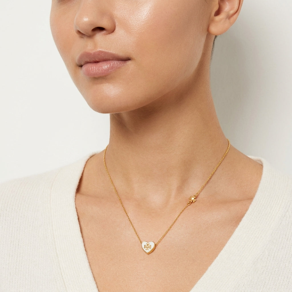 Model wearing Tory Burch Kira Heart Necklace, an elegant choice for a minimalist jewelry look