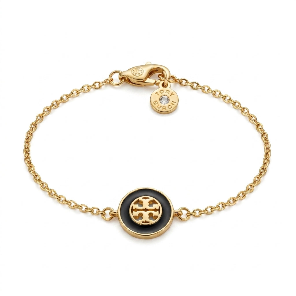 High-resolution product image of the Kira Enamel Chain Bracelet on a white background, showing the gold-tone finish and logo.