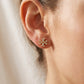 Model wearing Tory Burch Kira Pavé Studs, showcasing the chic gold-tone aesthetic for daily wear