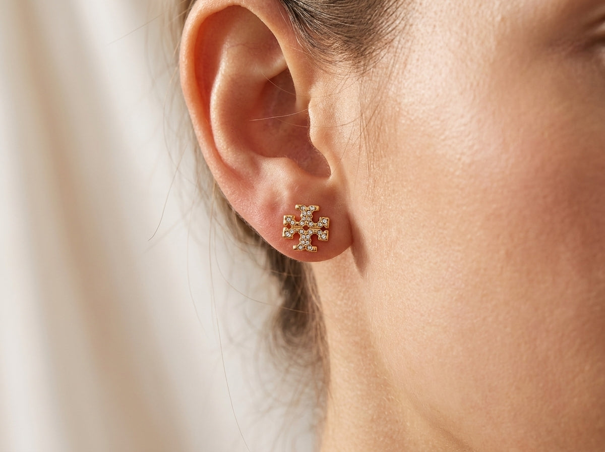 Model wearing Tory Burch Kira Pavé Studs, showcasing the chic gold-tone aesthetic for daily wear