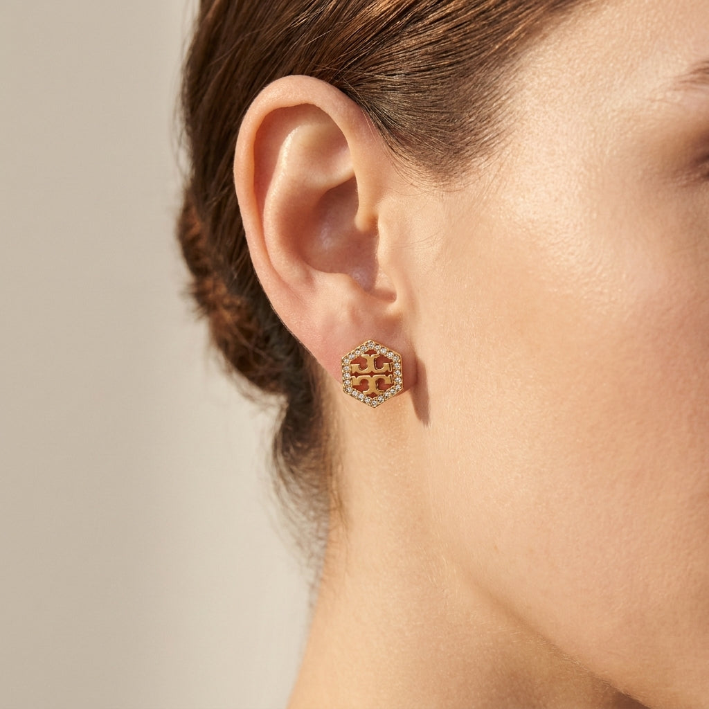 Close-up of model wearing Kira Logo T Pave Studs, showing a delicate glimmer for everyday luxury