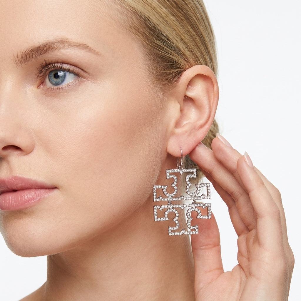 The Tory Burch large openwork Double T logo earrings in silver plated brass, fully encrusted with shimmering pave crystals.