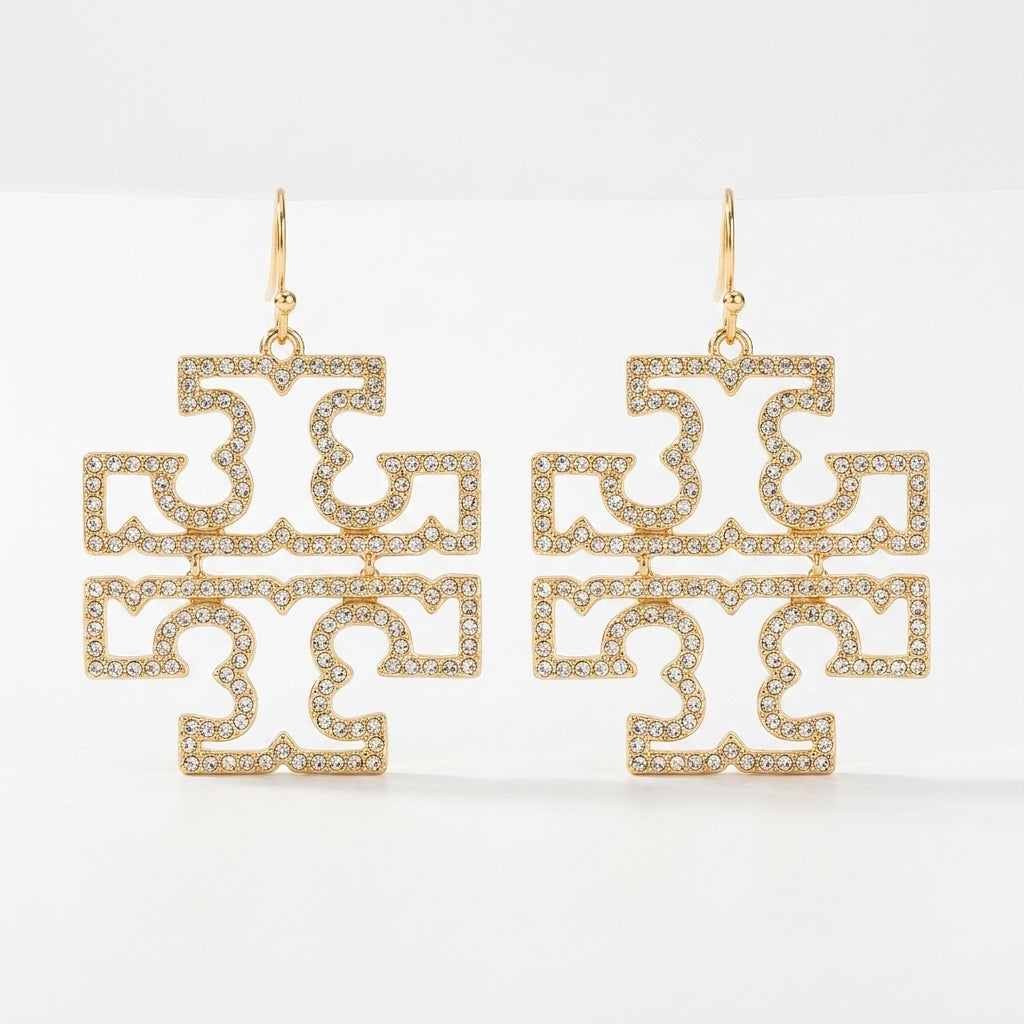 A pair of Tory Burch large Double T logo statement earrings in 18k gold plated brass, featuring openwork pave crystal accents.