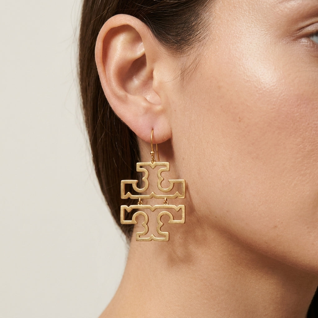 Model wearing Tory Burch Large Logo Earrings, showcasing the bold statement effect for modern styling