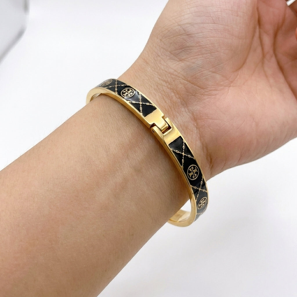 Model wearing Tory Burch Miller Enamel Hinge Bangle, showcasing a chic effortless luxury stack