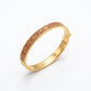 Tory Burch Miller Enamel Logo Hinge Bracelet in gold-tone with vibrant enamel inlay and cutout Double T