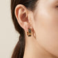 Model wearing Tory Burch Small Icon T Monogram Earrings for a chic, minimalist everyday jewelry look