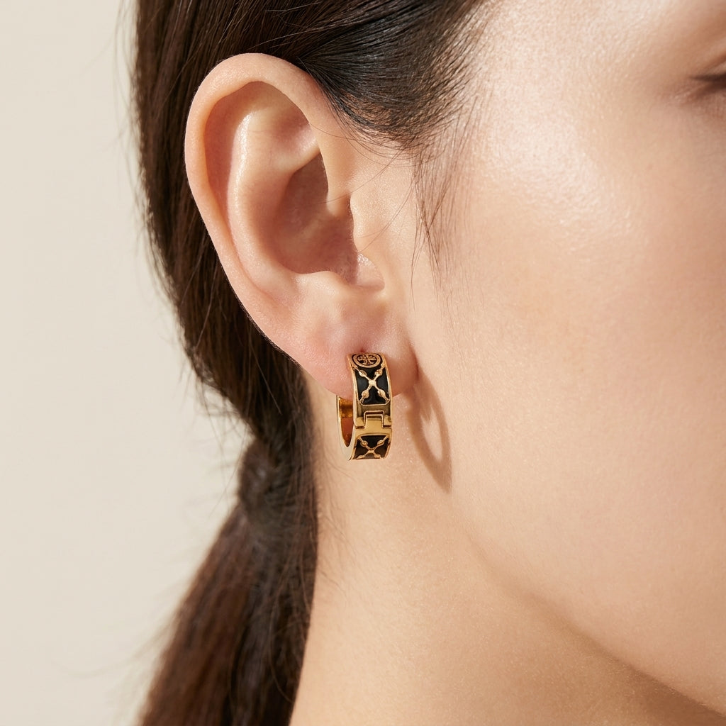 Model wearing Tory Burch Small Icon T Monogram Earrings for a chic, minimalist everyday jewelry look