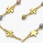 Detailed shot of the lobster clasp and the signature Double T logo tag on the pearl bracelet