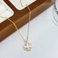 Front view of the Tory Burch Moondance gold-tone necklace featuring the signature logo pendant.