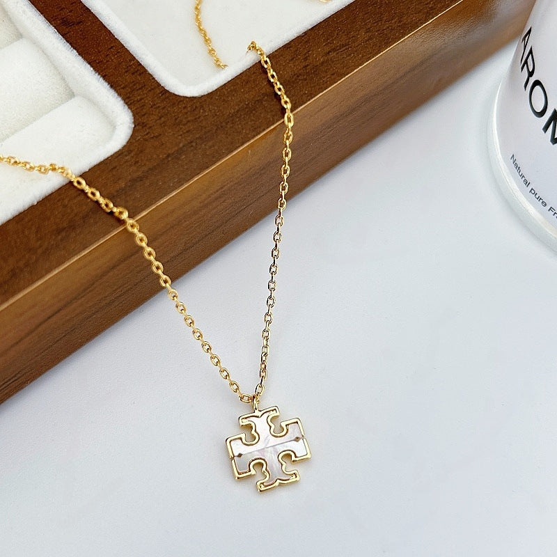 Front view of the Tory Burch Moondance gold-tone necklace featuring the signature logo pendant.