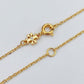 Detailed shot of the lobster clasp and adjustable extender chain on the Tory Burch Moondance necklace.
