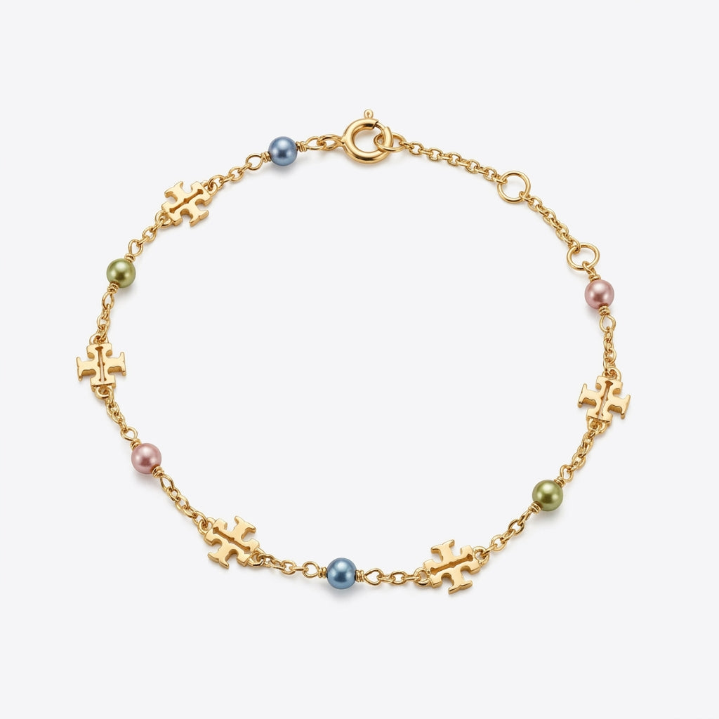 Tory Burch Moondance Pearl Bracelet featuring a delicate gold chain and high-luster pearls