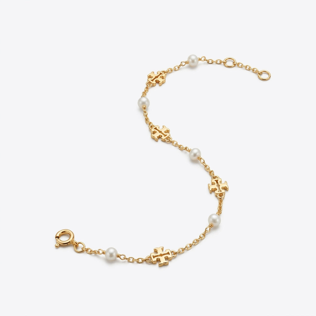 Tory Burch Moondance Pearl Bracelet featuring a delicate gold chain and high-luster pearls