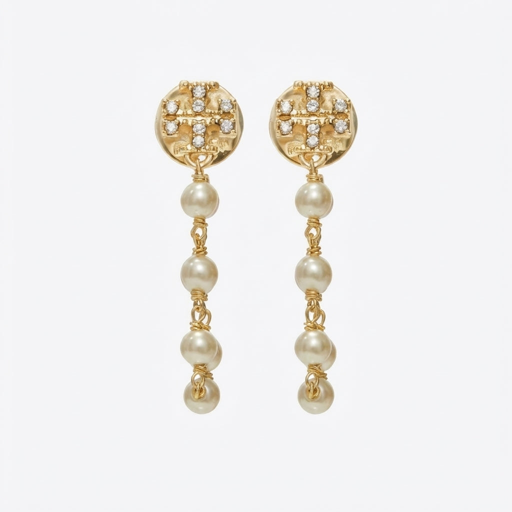 Tory Burch Moondance Pearl and Chain Earrings in gold-tone finish with a signature Double-T logo and drop pearl.