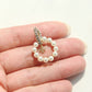 Close-up macro view of authentic tory burch moondance white pearl hoop earrings held in a person's palm showing scale.