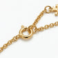 Detailed shot of the secure lobster clasp and adjustable extender on the gold flower necklace