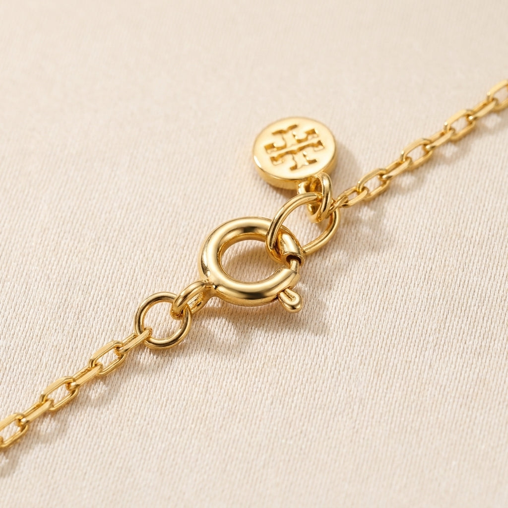 Detailed shot of the lobster clasp and adjustable extender on the Britten gold layered necklace