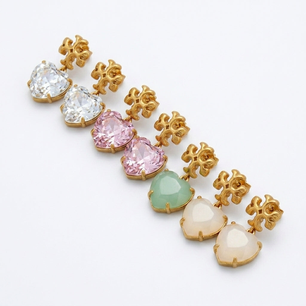 Angled side view of Tory Burch Pink Crystal Heart Earrings showing the depth and prong setting