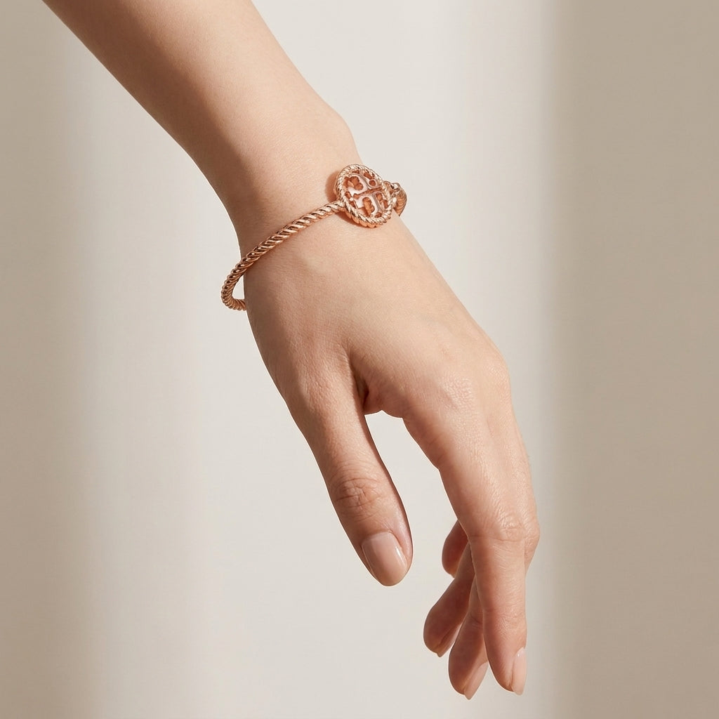 Model wearing Tory Burch Rope Logo Cuff, showcasing a chic minimalist effortless luxury look