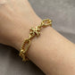 Model wearing Tory Burch Roxanne Gold Chain Bracelet for a bold and sophisticated statement look