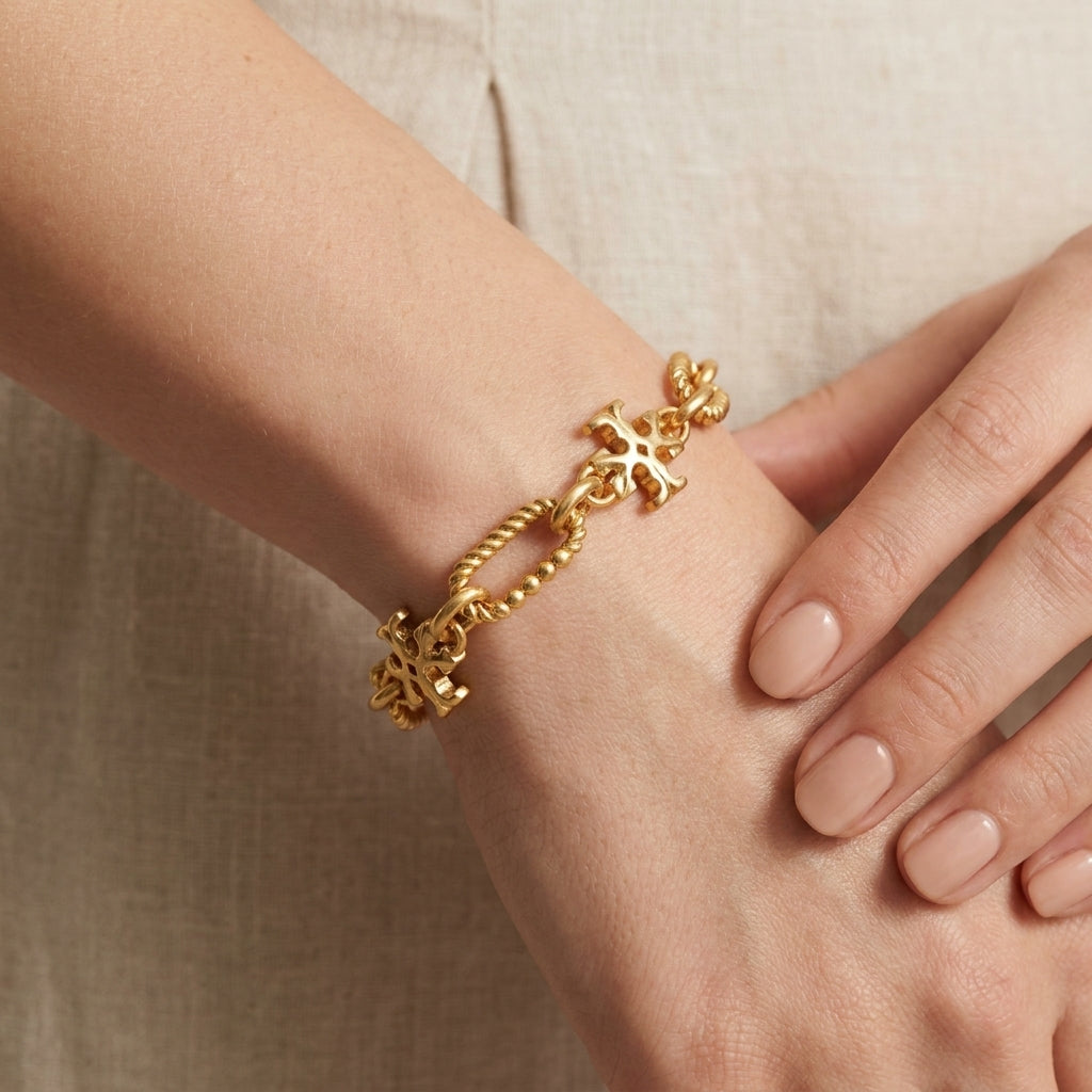 Model wearing Tory Burch Roxanne Gold Chain Bracelet for a bold and sophisticated statement look