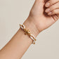 Model wearing Tory Burch Roxanne Short Chain Bracelet, perfect for effortless luxury layering