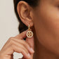 Model wearing Tory Burch Crystal Double T Hoop Earrings, perfect for adding glamour to any outfit