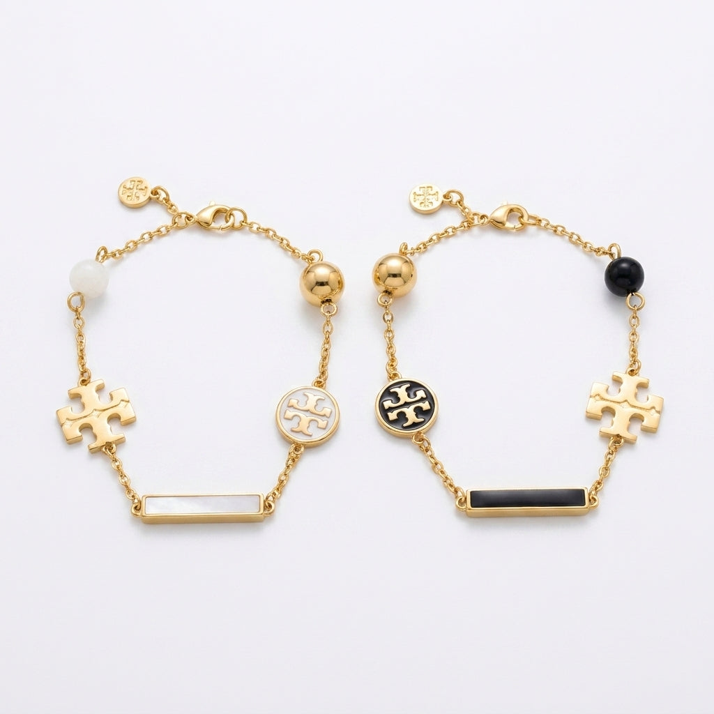 Tory Burch TB Logo and Pearl Bracelet in gold-tone featuring polished Double T and cream pearls