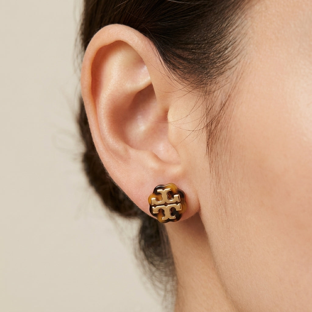 Model wearing Tory Burch Double Tone Earrings, demonstrating a modern and versatile jewelry look