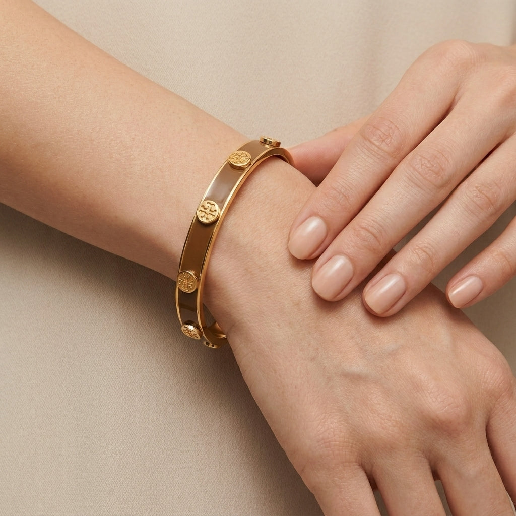Model wearing Tory Burch White and Gold Bangle, showcasing a chic and effortless luxury style